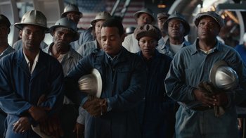 Movie still from “A League of Their Own” (2022), created by Abbi Jacobson – A group of men standing next to each other; Medium shot, Low angle