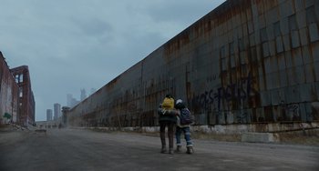 Two people standing next to each other on the side of the road
