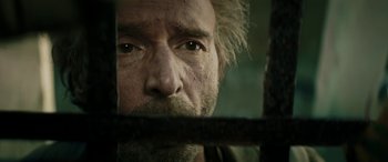 Movie still from “Pinocchio” (2019), directed by Matteo Garrone – A person behind a metal fence; Close Up shot, Low angle