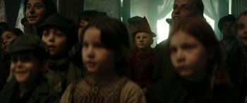 Movie still from “Pinocchio” (2019), directed by Matteo Garrone – A group of people standing in a room; Close Up shot, Over the shoulder angle