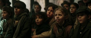 Movie still from “Pinocchio” (2019), directed by Matteo Garrone – A group of young children sitting in a room; Close Up shot, Low angle