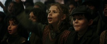 Movie still from “Pinocchio” (2019), directed by Matteo Garrone – A group of children standing in a crowd of people; Close Up shot, Low angle