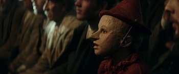 Movie still from “Pinocchio” (2019), directed by Matteo Garrone – The face of a wooden puppet; Close Up shot, High angle