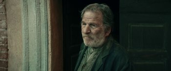 Movie still from “Pinocchio” (2019), directed by Matteo Garrone – An old man with a beard and a jacket; Close Up shot, Low angle