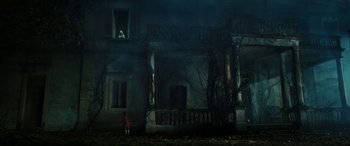 Movie still from “Pinocchio” (2019), directed by Matteo Garrone – A girl standing in front of an abandoned house; Extreme Wide shot, Low angle