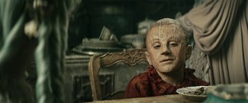 Movie still from “Pinocchio” (2019), directed by Matteo Garrone – A wooden head sitting on top of a wooden chair; Close Up shot, Low angle