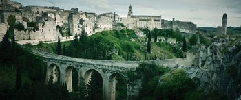 Movie still from “Pinocchio” (2019), directed by Matteo Garrone – A view of a city with a bridge in the foreground; Extreme Wide shot, Low angle