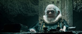 Movie still from “Pinocchio” (2019), directed by Matteo Garrone – An old man with a beard and a monkey mask; Close Up shot, Low angle