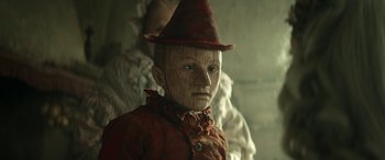 Movie still from “Pinocchio” (2019), directed by Matteo Garrone – A person wearing a hat; Close Up shot, Low angle