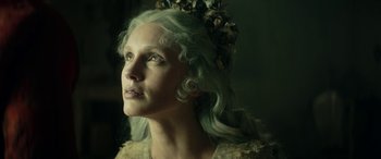 Movie still from “Pinocchio” (2019), directed by Matteo Garrone – A person with green hair; Close Up shot, Low angle