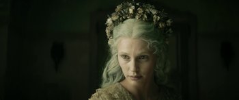 Movie still from “Pinocchio” (2019), directed by Matteo Garrone – A woman with a flower crown on her head; Close Up shot, High angle