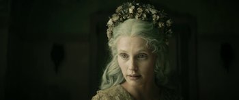 Movie still from “Pinocchio” (2019), directed by Matteo Garrone – A woman wearing a flower crown and a lace dress; Close Up shot, Over the shoulder angle