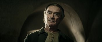 Movie still from “Pinocchio” (2019), directed by Matteo Garrone – An old man with a beard and a mustache; Close Up shot, Low angle