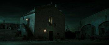 Movie still from “Pinocchio” (2019), directed by Matteo Garrone – A building that has a window lit up at night; Extreme Wide shot, Low angle