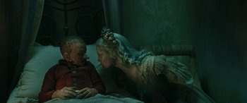 Movie still from “Pinocchio” (2019), directed by Matteo Garrone – A woman in a wedding dress kissing a man on the forehead; Close Up shot, High angle