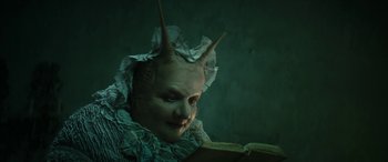 Movie still from “Pinocchio” (2019), directed by Matteo Garrone – A person with a book in their hands; Close Up shot, High angle