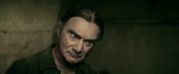 Movie still from “Pinocchio” (2019), directed by Matteo Garrone – An older man with a frowning look on his face; Close Up shot, Over the shoulder angle