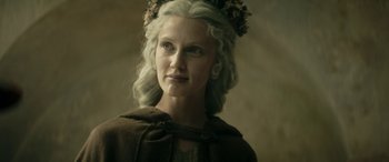 Movie still from “Pinocchio” (2019), directed by Matteo Garrone – A woman with long white hair and a flower crown; Close Up shot, Low angle