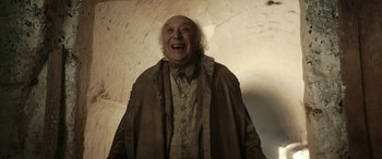 Movie still from “Pinocchio” (2019), directed by Matteo Garrone – An old man is smiling for the camera; Medium shot, Low angle