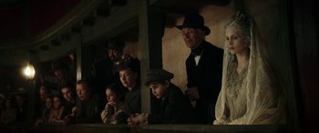 Movie still from “Pinocchio” (2019), directed by Matteo Garrone – A group of people sitting next to each other; Medium shot, Low angle