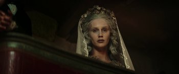 Movie still from “Pinocchio” (2019), directed by Matteo Garrone – A woman in a white veil looking into a mirror; Close Up shot, Low angle