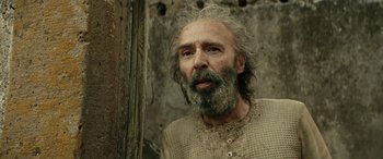 Movie still from “Pinocchio” (2019), directed by Matteo Garrone – An old man with a beard and long grey hair; Close Up shot, Low angle