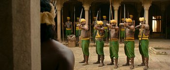 A group of men standing next to each other holding arrows