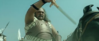 A man dressed in armor holding a sword
