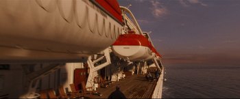 Movie still from “Poseidon” (2006), directed by Wolfgang Petersen – A man standing on the deck of a boat; Extreme Wide shot, High angle