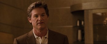 Movie still from “Poseidon” (2006), directed by Wolfgang Petersen – A person wearing a suit and tie; Close Up shot, Over the shoulder angle