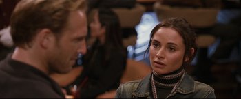 Movie still from “Poseidon” (2006), directed by Wolfgang Petersen – A man and a woman are sitting at a table; Close Up shot, Over the shoulder angle