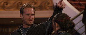 Movie still from “Poseidon” (2006), directed by Wolfgang Petersen – A person raising his hand; Close Up shot, Over the shoulder angle