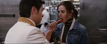 Movie still from “Poseidon” (2006), directed by Wolfgang Petersen – A man and a woman are eating food together; Close Up shot, Over the shoulder angle
