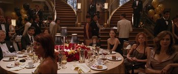 Movie still from “Poseidon” (2006), directed by Wolfgang Petersen – A group of people sitting around a table with food on top of it; Wide shot, Over the shoulder angle