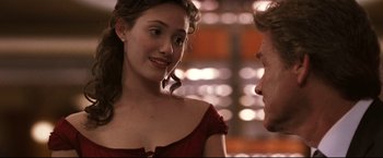 Movie still from “Poseidon” (2006), directed by Wolfgang Petersen – A woman in a red dress talking to a man in a red dress; Close Up shot, Over the shoulder angle