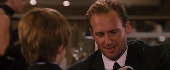 Movie still from “Poseidon” (2006), directed by Wolfgang Petersen – A man wearing a suit and tie talking to another man wearing a suit and tie; Close Up shot, Over the shoulder angle