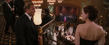 Movie still from “Poseidon” (2006), directed by Wolfgang Petersen – A man standing on top of a spiral stair case; Medium shot, Over the shoulder angle
