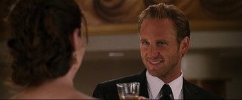 Movie still from “Poseidon” (2006), directed by Wolfgang Petersen – A man and a woman are sitting at a dinner table; Close Up shot, Over the shoulder angle