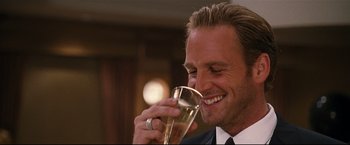 Movie still from “Poseidon” (2006), directed by Wolfgang Petersen – A person drinking a glass of wine; Close Up shot, Low angle