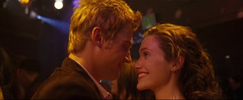 Movie still from “Poseidon” (2006), directed by Wolfgang Petersen – A man and a woman smiling at each other; Close Up shot, Over the shoulder angle