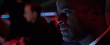 Movie still from “Poseidon” (2006), directed by Wolfgang Petersen – A man's face in a dark room; Close Up shot, Over the shoulder angle