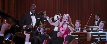 Movie still from “Poseidon” (2006), directed by Wolfgang Petersen – A group of people at a party drinking and singing; Medium shot, High angle