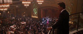 Movie still from “Poseidon” (2006), directed by Wolfgang Petersen – A crowd of people in a large room with lights on; Extreme Wide shot, High angle