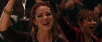 Movie still from “Poseidon” (2006), directed by Wolfgang Petersen – A beautiful young lady smiling for the camera; Close Up shot, Over the shoulder angle