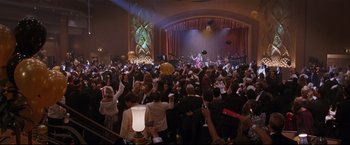 Movie still from “Poseidon” (2006), directed by Wolfgang Petersen – A crowd of people in a room with lights on; Extreme Wide shot, High angle