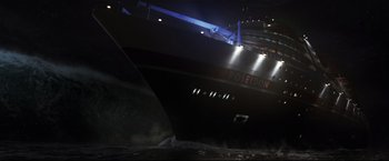 Movie still from “Poseidon” (2006), directed by Wolfgang Petersen – A large boat in the water at night time; Extreme Wide shot, High angle