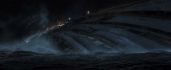 Movie still from “Poseidon” (2006), directed by Wolfgang Petersen – A ship in the water at night with lights on it; Extreme Wide shot, High angle