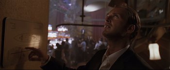 Movie still from “Poseidon” (2006), directed by Wolfgang Petersen – A man in a suit looking up at the ceiling of a room; Close Up shot, Low angle