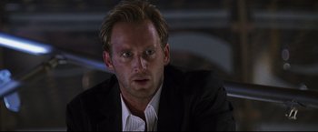Movie still from “Poseidon” (2006), directed by Wolfgang Petersen – A person wearing a suit and tie; Close Up shot, Low angle