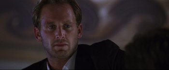 Movie still from “Poseidon” (2006), directed by Wolfgang Petersen – A person wearing a suit and tie; Close Up shot, Low angle